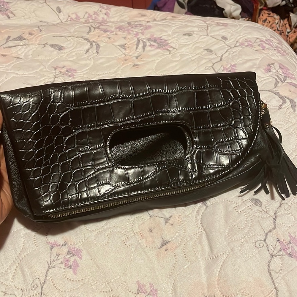 Small black Steve Madden fold over clutch. One side snake skin design.